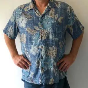 Hawaiiskjorta köpt i Arizona, skön silke som tål tvätt. Alla knappar finns, ren och snygg. Ett pyttelitet hål bak långt ner som inte syns.