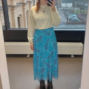 Paisley mönstrad maxi klänning - Blå maxiklänning med lila paisley mönster. Vitt sidenbands axelband med knytdetaljer. Uppskattad storlek S/M.