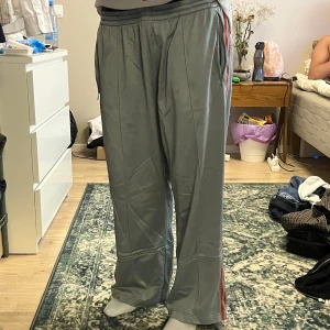 adidas byxor - gråa/oranga adidas byxor! baggy fit. de har några fläckar på framsidan som inte går bort, men inget som syns så tydligt. jag är 166! 