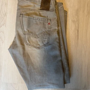 Replay jeans  - Gråa replay jeans modell anbass w 33 Lår mått:25cm, ben öppning 19cm, midja:45cm.ytter ben:100cm, innerbenslängd:75cm