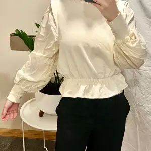 Ruffle beige blouse from Gina Tricot