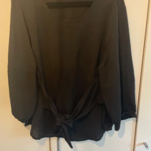 Blus - Topp med band att kunna knyta på fram eller baksida.  Storlek L