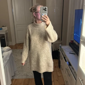 Stickad tröja från Mango  - Säljer denna jätte fina stickade tröjan i färgen kaki/beige som är väl använd, lite nopprig. Tröjan är väldigt overzized