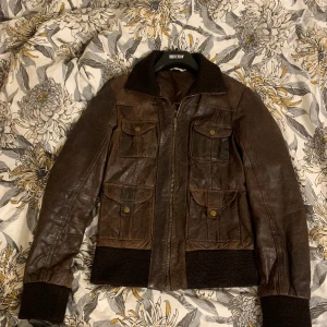 Brun fejk  läder jacka  - En jättefin brun fejk läderjacka i retro stil, i storlek 38 men passar även mindre ☺️ Använd gärna köp nu ❤️