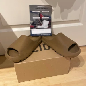 Yeezy slides - Hej säljer min snygga och bekväma slides köpta på sneakerhyllan för 1599kr själv klart äkta. Säljer dom för att dom inte används, skick 7/10 adidas logan på hälen är lite sliten men man kan fortfarande se den. Fråga om fler bilder