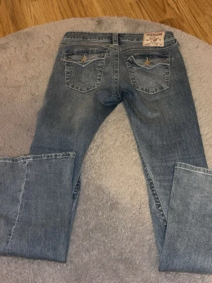 True religion jeans dam - Säljer ett par klassiska blå bootcut jeans med låg midja och lätt slitning framtill. Säljs pågrund av att jeansen är för långa för mig,jeansen är i nytt skick men har några fläckar längst ner vid ena benet lite utan på jeansen men de mesta innan för jeansen längst ner vilket knappt syns om man inte kollar noggrant går troligtvis bort med lite vanis och en tvätt,köpte på Nelly för 1300kr💓💓