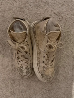 Chloé Lauren lace sneakers  - Chloé sneakers - Nypris 5200kr!  Äkthetsbevis: serienummer, logotyper (ej kvar dustbag + kartong)Defekter: Skorna är i bra bruksskick och med en enkel tvätt kan de fräschas upp ytterligare. Mindre slitage finns på insidan vid hälarna, men det påverkar varken funktion eller utseende utvändigt. Ett litet hål på utsidan kan ibland öppna sig, men är enkelt att åtgärda me med lite lim eller några stygn. Även loggans bokstäver kan lätt fästas igen. 