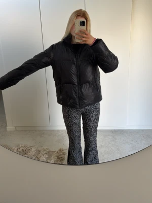 Leopardmönstrade täckbyxor 8848 - Säljer ett par leopardmönstrade täckbyxor från 8848. Byxorna har utsvängda ben och är fodrade för extra värme. De är svarta och gråa med elastiska muddar vid bensluten. Perfekta för dig som vill sticka ut i backen! Och jag är ca 170 lång och dem sitter perfa!