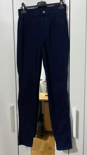 Mörkblå raka jeans - Säljer ett par mörkblå jeans med rak passform och klassisk femficksdesign. Jeansen har bälteshällor och stängs med knapp och dragkedja. Perfekta till en avslappnad stil och funkar året runt. Mått: midjan är 33cm och längden är 96cm. 💕