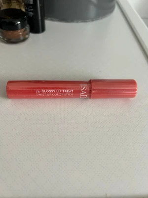 Isadora Glossy Lip Treat Beach Peach - Säljer ett Isadora The Glossy Lip Treat Twist-Up Color Stick i färgen 09 Beach Peach. Läppstiftet har en glossig finish och kommer i en smidig pennformad förpackning i persikoorange nyans. Perfekt för dig som vill ha färg och glans i ett steg.