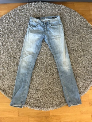 Ljusblå skinny jeans från Dondup - Snygga jeans från Dondup i en fin ljusblå stonewashed färg. Slim/straight passform med klassiska detaljer som karakteristiska bakfickor och märkets logga. Naturliga slitage-markeringar som ger dem en äkta vintage-känsla. Perfekta för en avslappnad men stilren look! ✨