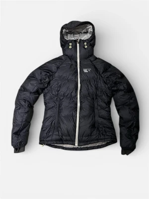 Svart Mountain Hardwear dunjacka - Mountain Hardwear Women’s Phantom Hooded Down Jacket  Lätt och teknisk dunjacka för alpin klättring och turer i kyla. • Modellnr: OL4506 • Tillverkad ca 2011 • Nypris runt 4 000 kr Jackan är i mycket bra skick men har ett litet hål i höger ficka (se sista bilden) Perfekt förstärkningsplagg för fjäll, skid- och vinteräventyr.
