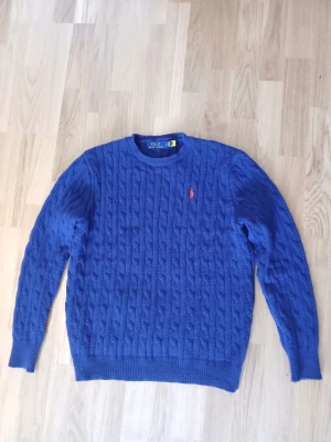 Blå kabelstickad tröja Polo Ralph Lauren - Snygg blå kabelstickad tröja från Polo Ralph Lauren använd väldigt lite storlek S
