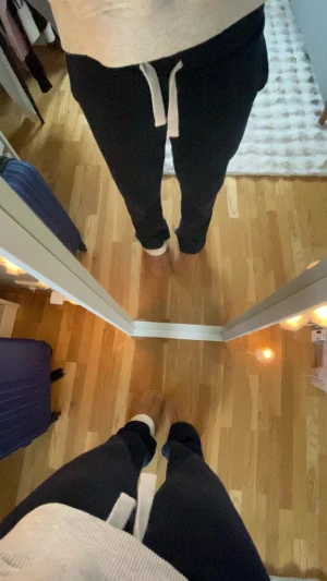 Mörkblå mjukisbyxor från Gina Tricot - Mörkblå mjukisbyxor från Gina Tricot med vit snörning i midjan och bekväma sidofickor. Perfekta för en avslappnad stil och tillverkade i mjukt bomullsmaterial. Klassisk loose passform som ger en chill vibe.