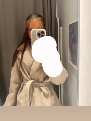 Beige kappa med knytskärp - Säljer en beige kappa i jätte bra skick med knappar och knytband 