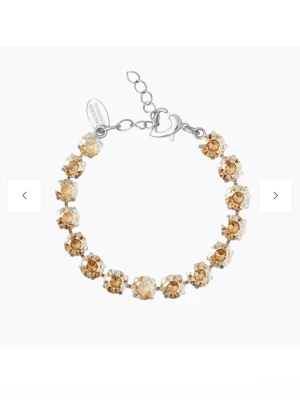 Armband med guldtonade kristaller - Såå fint armband från Caroline Svedbom med stora, runda kristaller i guld- och champagneton på en silverfärgad kedja. Fick i födelsedagspresent, men blev fel så aldrig använt!!