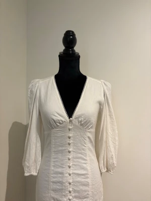 Vit klänning i linne - Kortare linneklänning.