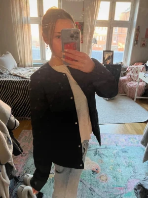 Mörkblå vårjacka med tryckknappar - Snygg svart tunn pufferjacka/täckjacka med raka linjer och tryckknappar framtill. Färgen syns bäst på bild 3!!🥰 storlek: 170, men skulle säga att den passar xs/s