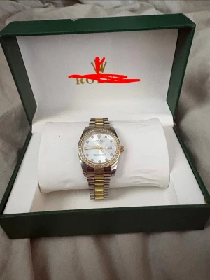 En fin klocka - En klocka i guld och silver med stenar. 