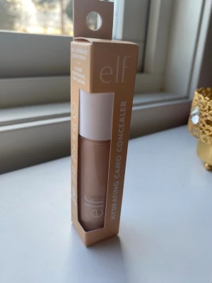 e.l.f. Hydrating Camo Concealer Fair Warm - e.l.f. Hydrating Camo Concealer i nyansen Fair Warm.  Den är använd några fåtal gånger, så nästan helt full. Säljer för att färgen inte passade mig.