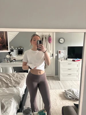 Bruna ribbade leggings med utsvängda ben - Säljer ett par bruna leggings med ribbad struktur och utsvängda ben. De har hög midja och är gjorda i ett stretchigt material som sitter bekvämt och följsamt. Perfekta för en avslappnad och trendig look.