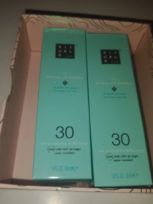 Rituals The Ritual of Karma SPF 30 spray - Två mintgröna förpackningar av Rituals The Ritual of Karma sun protection milky spray med SPF 30. Innehåller 50 ml vardera och är vattenresistent. Perfekt för att skydda huden mot solens strålar.