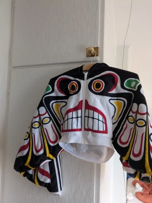 Adidas x Jeremy Scott 'totem' jacket - Selling an absolute masterpiece of streetwear  History: the highly sought-after Adidas x Jeremy Scott "Totem Pole" cropped track jacket / hoodie from the iconic 2013 collection.  Size: Small  Condition: Excellent vintage condition some pilling on the underside of the sleeves. Well preserved with vibrant colors and crisp graphics as seen in the pictures.