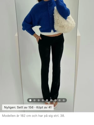 Svarta lowwaisted kostymbyxor - Snygga svarta kostymbyxor med bootcut och låg midja. Byxorna har en stilren look och passar perfekt till en trendig outfit. Materialet är mjukt och följsamt, vilket ger en bekväm känsla hela dagen.