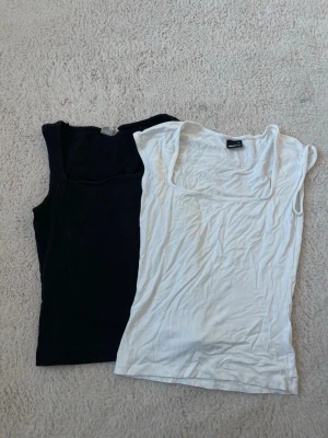 2 Gina Tricot toppar  - En svart och vit topp från Gina Tricot. Jätte sköna och perfekta som basplagg. Passar till allt. Den vita är lite skrynklig men kommer strykas när köpt, om man nu vill det. Priset inkluderar båda topparna, om man bara vill ha en topp hör av dig gärna!