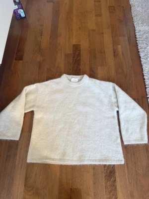 Ljusbeige stickad tröja från hm - Mysig ljusbeige stickad tröja från hm med rak passform och rund halsringning. Tröjan har långa ärmar och är gjord i mohair 