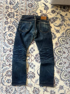 RRL japansk selvedge jeans - Jeans från Ralph Lauren Double RL i japanskt selvedge tyg. Byxorna har utvecklat kraftiga fades såsom honeycombs på baksidan.  Storlek W28 men utgå från måtten:  Ytterben: 92 cm  Innerben: 70 cm  Midja: 39 cm  Benöppning: 18 cm   Skriv vid frågor eller funderingar