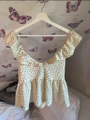 Prickig topp Gina Tricot - Supersöt prickig topp från Gina Tricot med knytning i ryggen. Storlek L. Superfint skick.