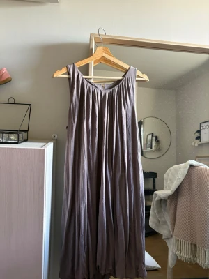 Ljuslila klänning Bruuns Bazaar - Säljer en ljuslila klänning från Bruuns Bazaar. Klänningen är ärmlös med vacker drapering och rund halsringning. Tillverkad i ett mjukt, tunt tyg som faller snyggt. Perfekt för dig som gillar en avslappnad men stilren look. Andvänd fåtalet gånger och i super fint skick! Klänningen är i storlek M men passar även S.