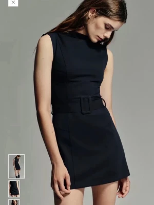 Svart kort klänning med bälte - Snygg svart kort klänning med ärmlös design och markerad midja med bälte. Så snygg och slutsåld på hemsidan ❤️Den är helt oanvänd, endast testad! 