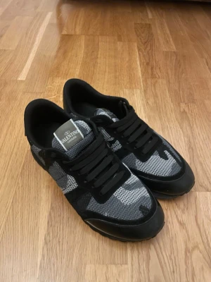 Valentino rockrunners - Snygga Valentino Rockrunners med svart och grått camouflagemönster. Perfekta för dig som vill sticka ut med exklusiva och trendiga skor.               Priset kan diskuteras vid snabb affär