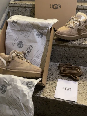 Uggs lomel shoe - Mycket fina och unika Uggs lomel i den beige:a färgen, skorna är i nytt skick med bara test användning, skorna kommer i storlek 38 med jätte skönt material innefrån som värmer foten i alla tider. Väldigt stiliga och passar alla stilar utan några konstigheter. Skriv gärna för mer information 😊