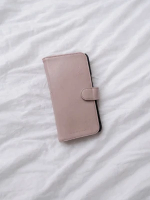 Rosa/Svart plånboksfodral från iDeal Of Sweden – iPhone 14 PM – Använt skick! - Ett stilrent plånboksfodral från iDeal of Sweden, designat för iPhone 14 Pro Max. Fodralet har en snygg rosa och svart färgkombination som ger både elegans och personlighet till din telefon. Det är välanvänt vilket syns på bilderna, men fortfarande helt funktionsdugligt! Kortplatser och magnetfunktion. Nypris 399kr! FÖRST TILL KVARN!