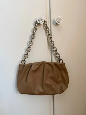 Väska  - Fin väska från hm, kedjan är guldig men ser silvrig ut på bild. Använd en gång, fint skick!