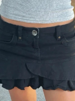 Svart volangkjol - Säljer en svart kortkjol med volangkant och fickor fram. Köpte den på en marknad i Spanien så vet inte vilket märke!! Säljer då den har blivit för liten för mig🫰pris kan diskuteras!!! 