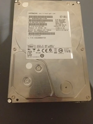 Hitachi intern hårddisk 2TB SATA - Intern hårddisk från Hitachi med 2TB lagringskapacitet och SATA 6.0 Gb/s anslutning. Metallhölje i silverfärg och kretskort på baksidan. Perfekt för stationära datorer som behöver extra lagring.
