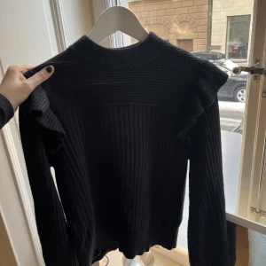 Tjocktröja med volanger - Superfin svart tjocktröja med volanger vid axlarna till salu!☺️