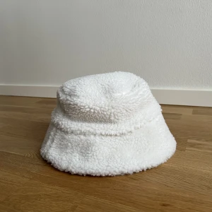 Bucket Hat - Får-ull liknande Bucket Hat som kan täcka över pannan. Väldigt bra skick, har bara använts 1 gång.
