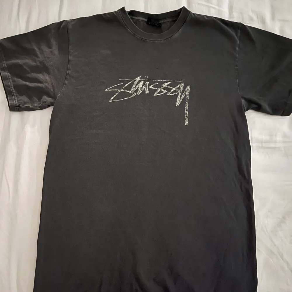 Loose fit T-shirt från Stüssy i en washed out grå/svart färg med vit distorted logo. Sparsamt använd. . T-shirts.