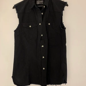 Ärmlös skjorta - Ärmlös skjorta i svart jeanstyg ifrån Carlings. Storlek M. Aldrig använd men köpt för många år sen. Fransiga slut vid armar och botten. 