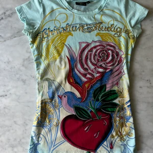 Christian Audigier T-shirt  - Christian Audigier T-shirt i nyskick, bomull med tryck och swarovski kristaller. Storlek small. Made in USA. Från samma designer som gjorde Ed Hardy!