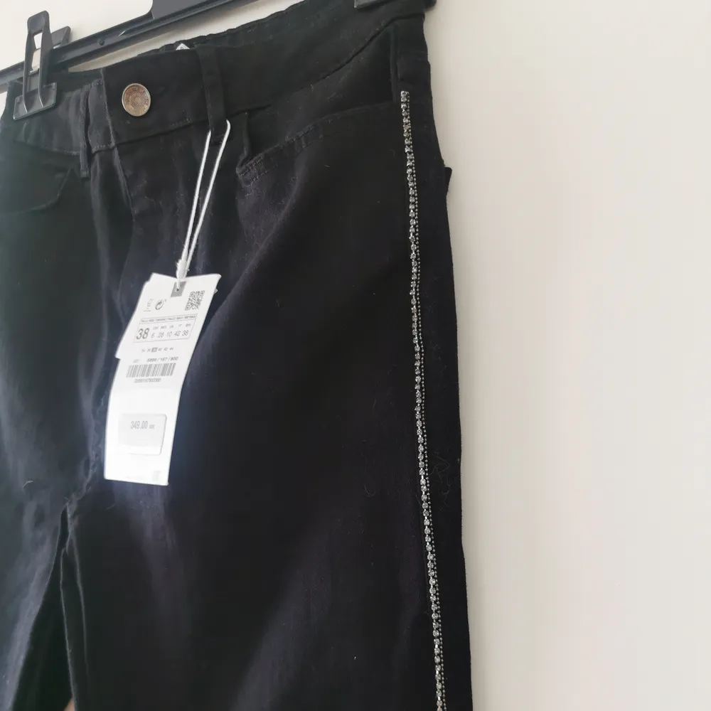 Nya jeans med lappar från Zara, strass stenar längs sidorna av byxan. Skinny high jeans. Jeans & Byxor.