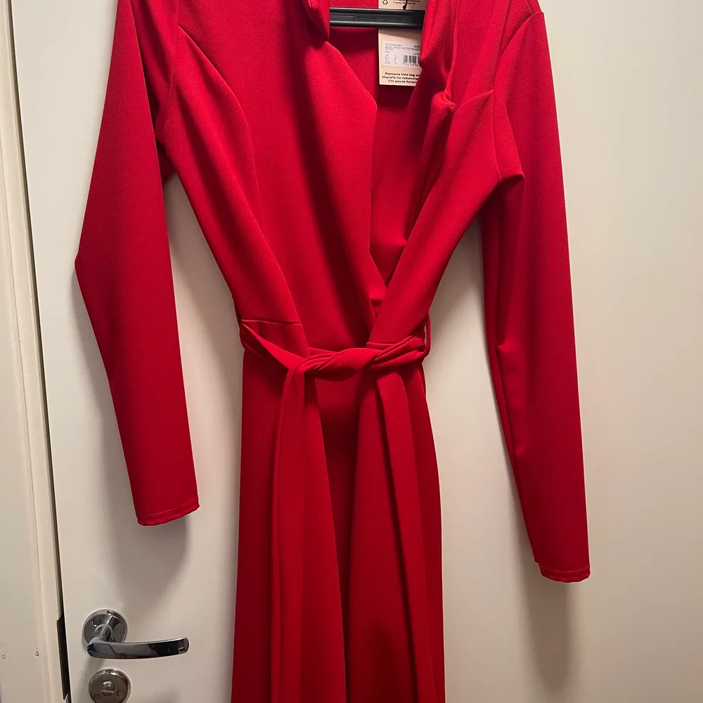 Klänningen är röd och är i storlek 40. Köpt för ca 1 månad sedan och helt oanvänd sedan dess. Köpt för 280kr. Klänningen går även att använda som kappa/blazer . Klänningar.