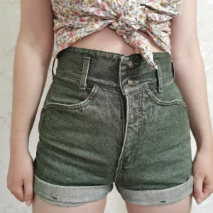 Högmidjade gröna jeansshorts - Skitcoola shorts som jag tyvärr har växt ur. Köpta secondhand på Myrorna, tror att de är från 80-talet. Kan skicka mått och bilder om du vill ha, det är bara att meddela mig :) 