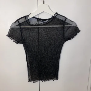 Mesh tröja strl xs - Svart glittrig mesh tröja, aldrig använd!