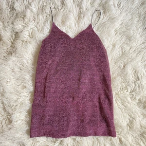 Glittrig klänning  - Kort glittrig klänning, oanvänd. S-M.